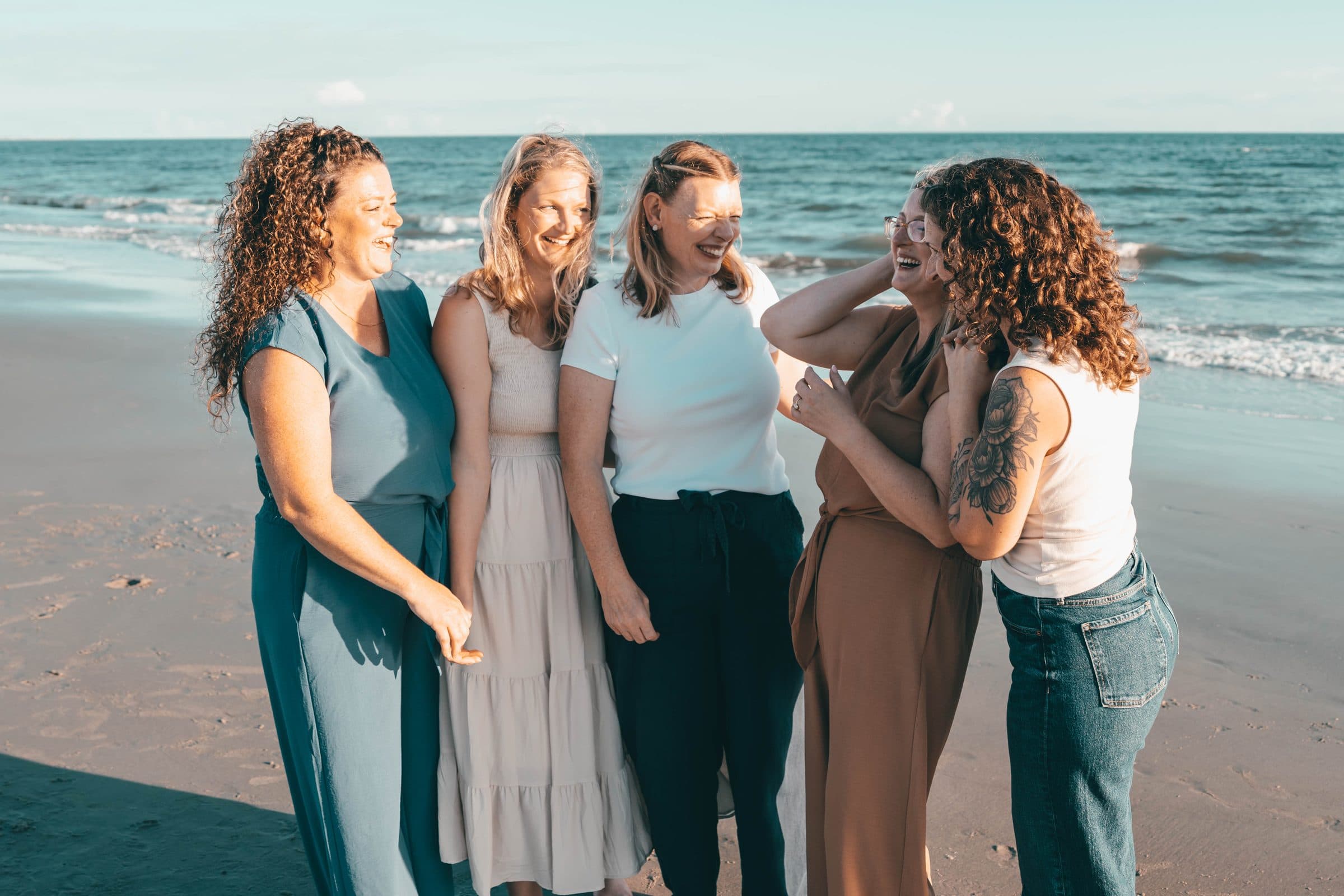 Sisters laughing together on the beach