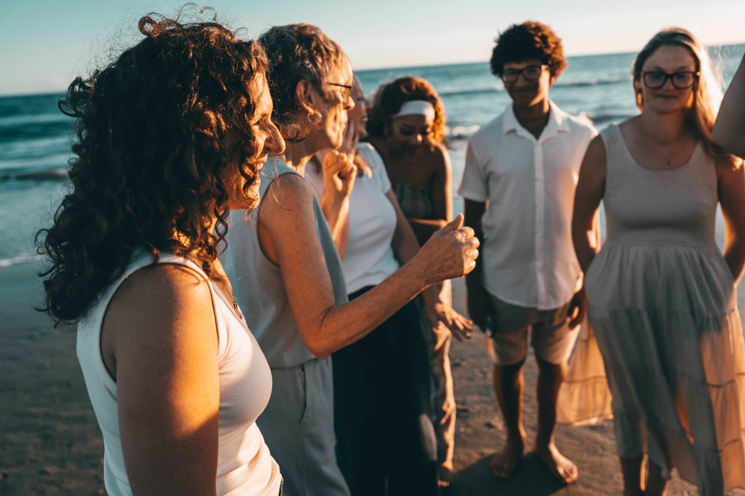 Family members celebrating together on the beach at golden hour